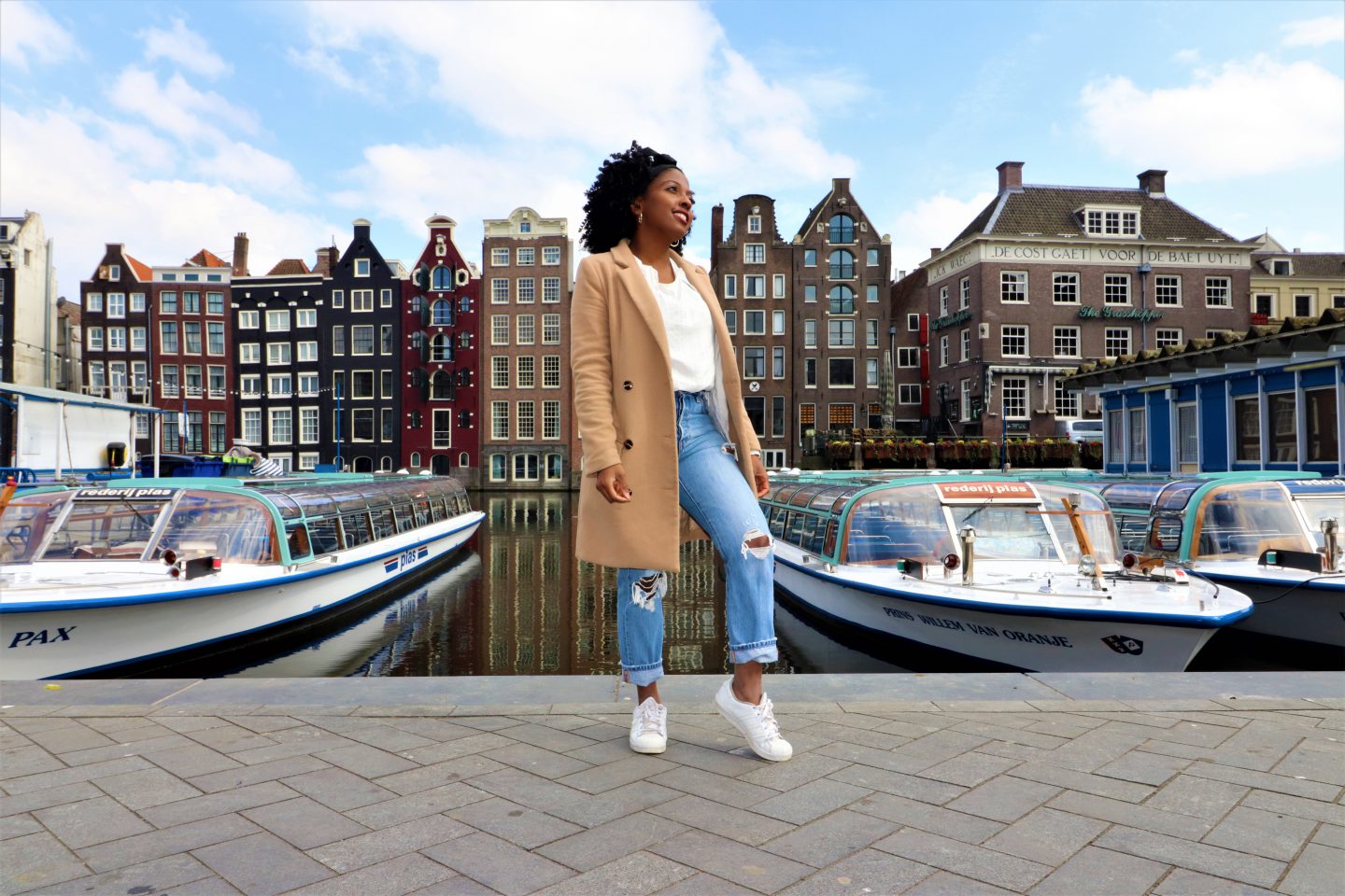 damrak, amsterdam, financial freedom, debt free community, the netherlands, camel coat, ripped jeans, adidas sneeakers, white t-shirt, afro hair, natural hair, kinky hair